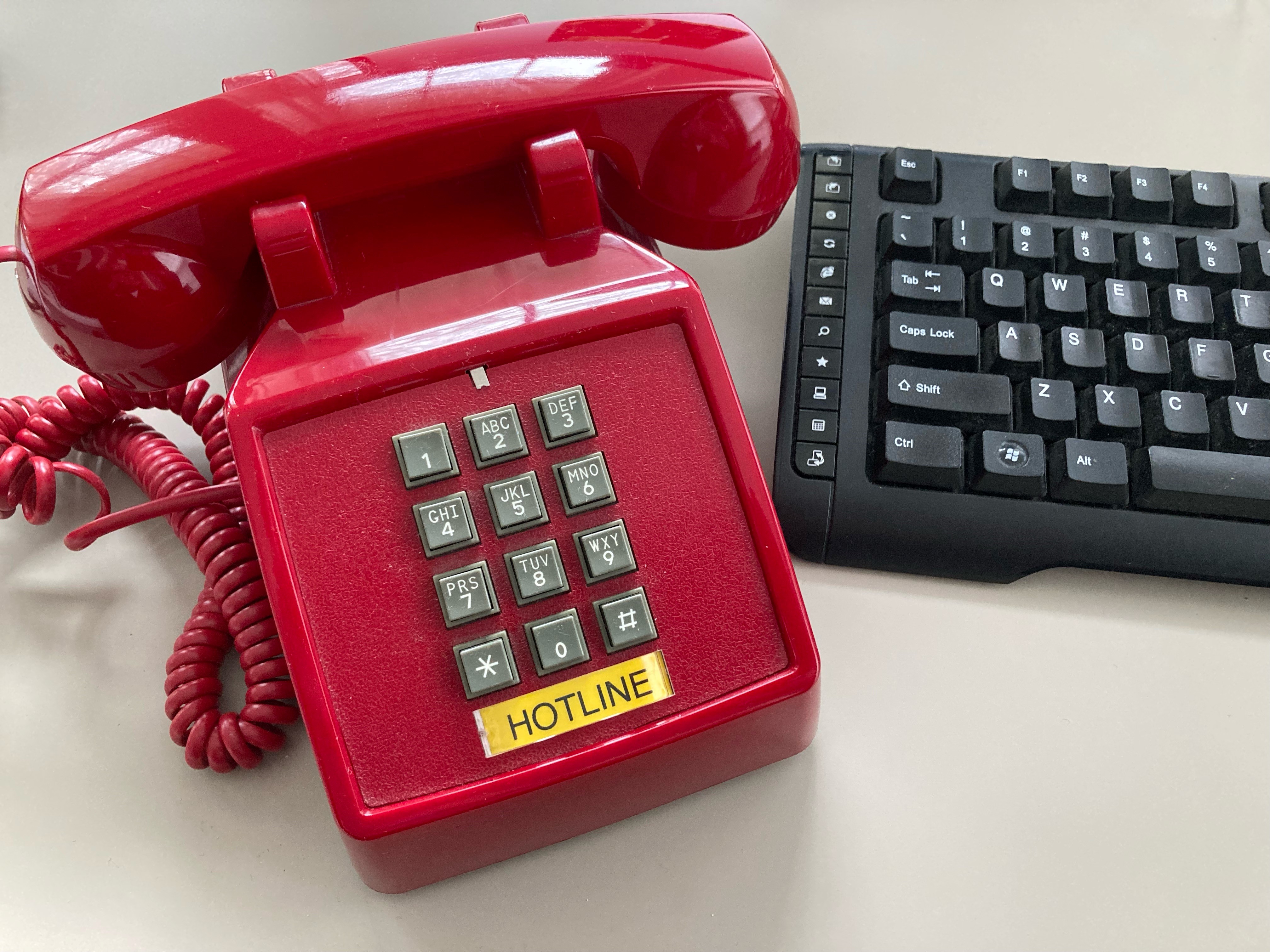 The PG Calc hotline to our Client Services team - image of a red hotline phone
